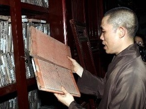 A monk holding a Buddhist Sutra woodblock at the Vinh Nghiem Pagoda in Bac Giang Province (Photo: VNA)